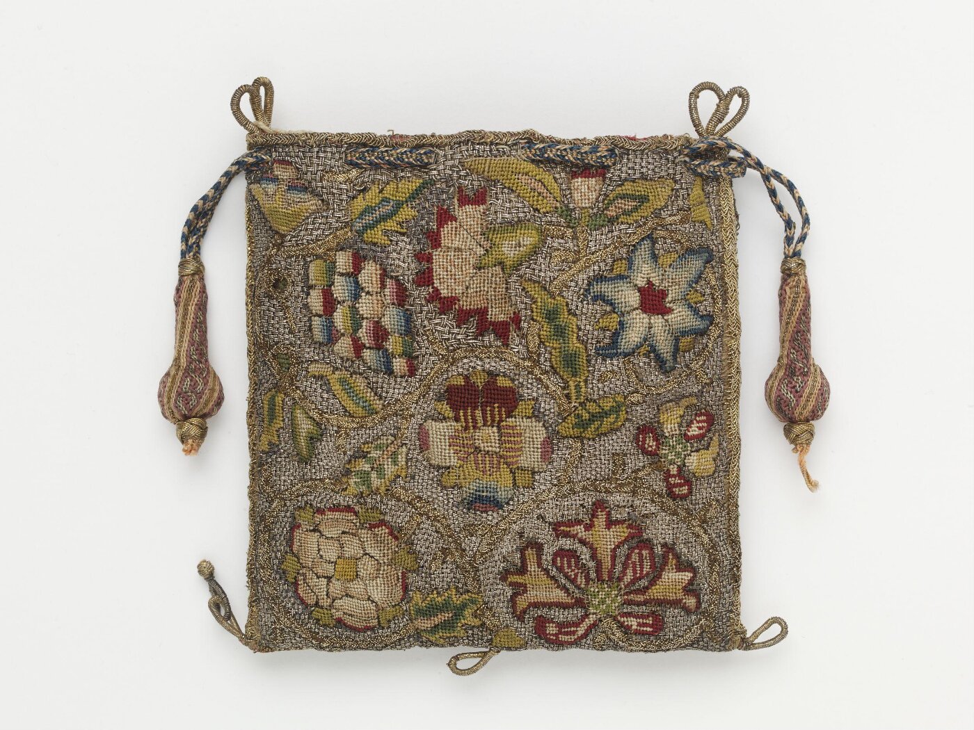 A photo of an old over-the-shoulder woven bag, with a flower and vetegable design