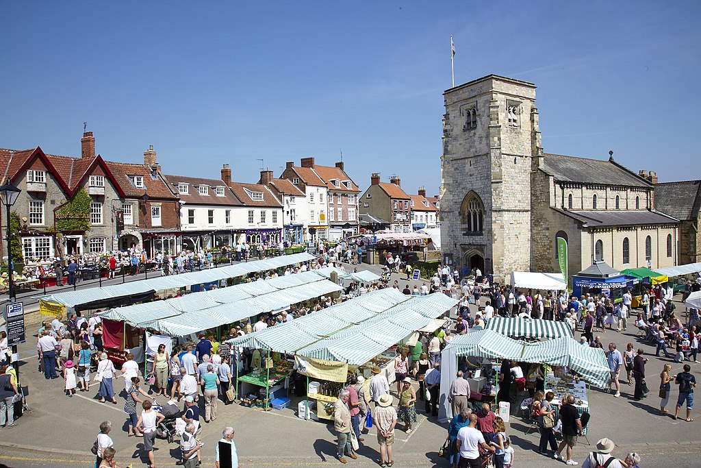 photograph of an old church with market stalls in the foreground